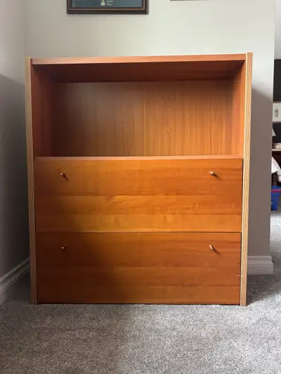 Sturdy wooden bookcase with a warm honey-brown finish. This unit has one large open shelf at the top...