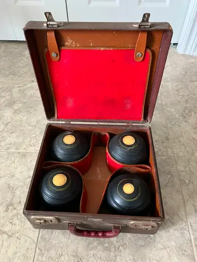 Vintage Townsend & Clark lawn bowling set. Comes with four lawn balls, and leather case with working...