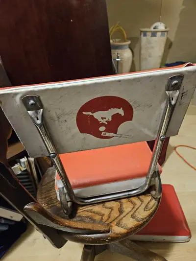 Add a vintage touch to any room with this unique swivel chair featuring a retro stamps logo on the b...