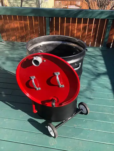 Brand new custom built Billy Barrel smoker. Fueled by briquettes and wood chips. Boasts 760 sq in sm...