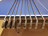 A full set of irons and woods with a stand bag