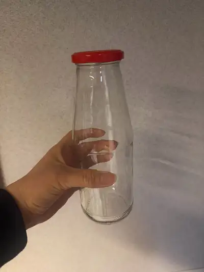 - 15 empty identical clear glass bottles with matching red lids - Formerly Unico strained tomato Pas...