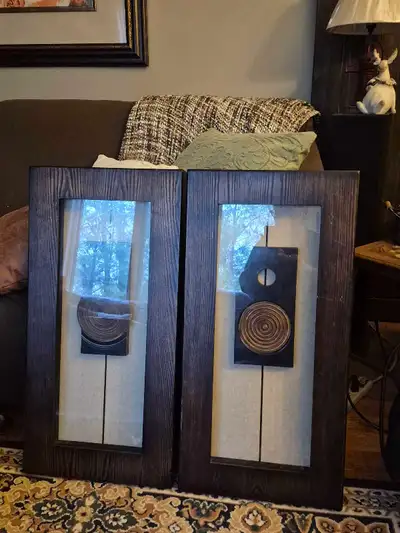 Elevate your home decor with this set of two matching wood-framed pictures, each featuring a unique...