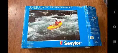 2 person inflatable kayak, more like a canoe 400lb capacity Comes with plastic paddles