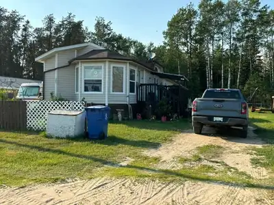 Trailer and lot for sale on fenced 100' x 100' lot. It has a new deck, 8' x 20' shed., close to rive...