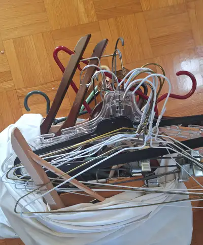 A variety of hangers for clothing, some for pants in metal, wood and plastic All for $15 -----------...