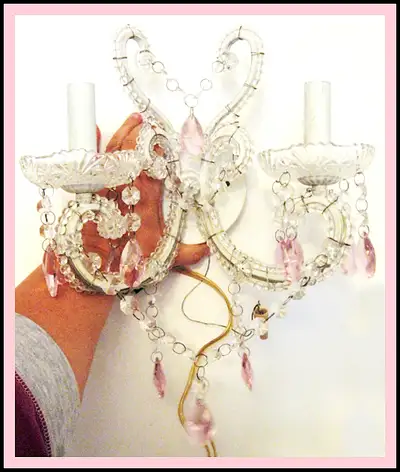 Exquisite white and pink chandelier sconce is accented bobeche, View more