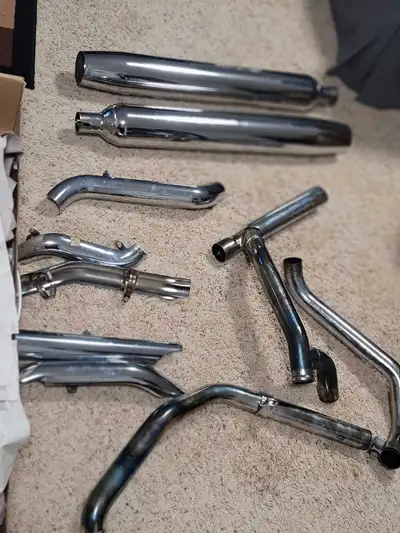 I'm offering a full exhaust system for a motorcycle, featuring chrome mufflers and headers. These ar...