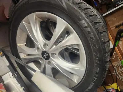 Offering a set of four Hyundai Sonata 17-inch aluminum rims paired with used winter tires, size 215/...