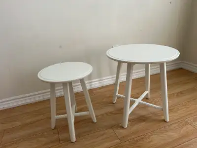 Two white side tables or stools, perfect for a living room or bedroom. Wooden construction. Smaller...