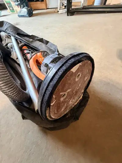 This is a pre-owned power drywall sander featuring an integrated LED work light and dust collection...