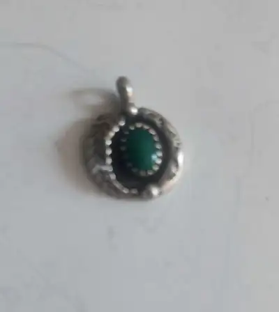 Check out this captivating SW Native American silver pendant, featuring a beautiful green Turquoise....