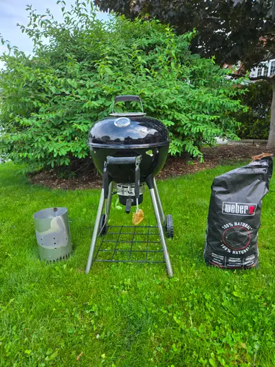 A charcoal grill that has been used once. It includes the BBQ (18 inch diameter), charcoal igniter,...