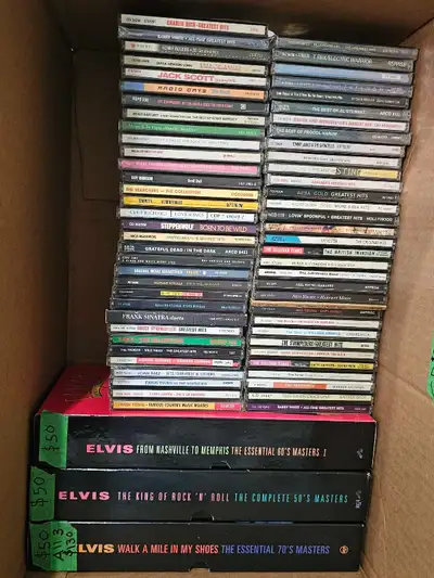 Dive into a treasure trove of musical history with this collection of used CDs, featuring a wide arr...