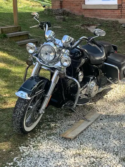 Take a ride on this used 2013 Harley Davidson Road King, a true classic with a sleek black finish th...