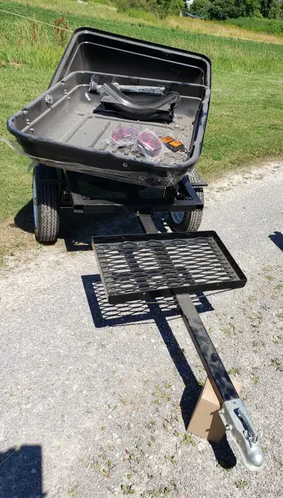 Trailer to tow behind. Tag along trailer Has place to hold cooler outside clamshell trailer. New. So...
