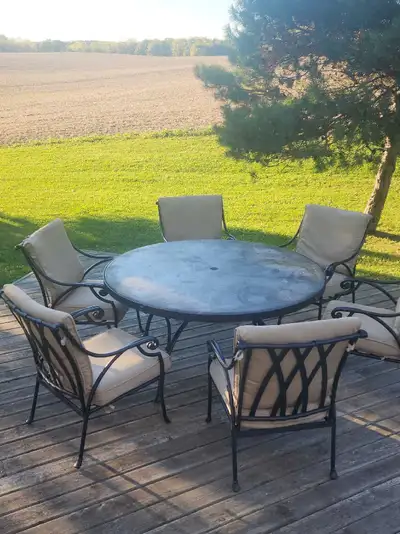 Extra Large 5 ft in diameter table with a stone tile top. This cast aluminum patio dining set is 5 y...