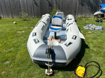 Innovocean 12.5 ft inflatable boat with 9.9 Mariner. Very good condition. Holds air, no holes or pat...