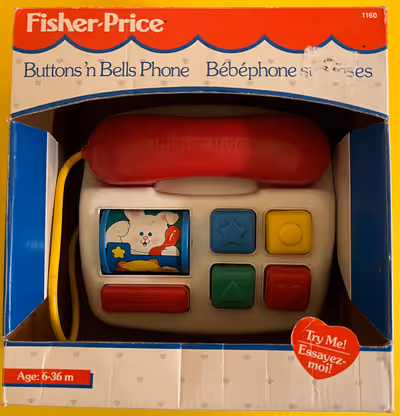Toy phone with buttons that will ring a bell or spin a roller when pressed. No batteries needed. Cle...