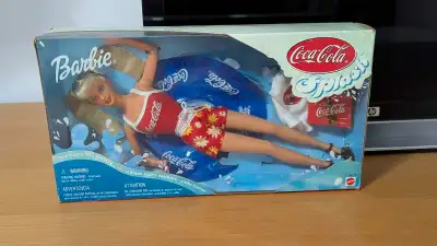 Dive into nostalgia with this 1999 Coca-Cola Splash Barbie, a special edition doll still sealed in i...