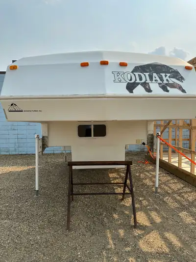 Kodiak camper, manual jacks, new camo decals, new entry door, great condition, no leaks, everything...