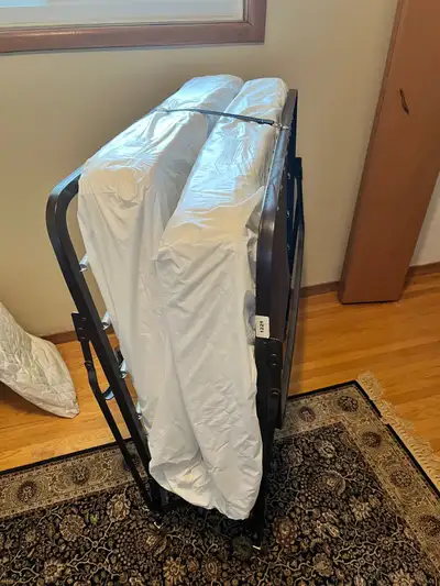 Single folding, roll away cot. Metal frame with a heavy fabric support base. Rarely used, clean and...
