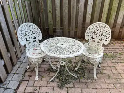 Vintage 3 piece: aluminum table and 2 heavy cast iron chairs out, View more
