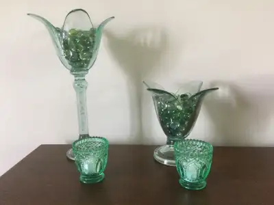 Green Votives set in Glass rocks. 7 & 13 inches high, 7 & 8 inches wide. Put in a solar light for yo...