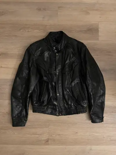This is a durable black leather jacket, perfect for adding an edgy touch to any outfit. It's a sturd...