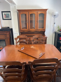 Extendable dinner table with chairs and hutch