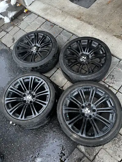Set of 4 aftermarket BMW-style wheels, 5x120 bolt pattern, staggered fitment. Gloss black finish, so...