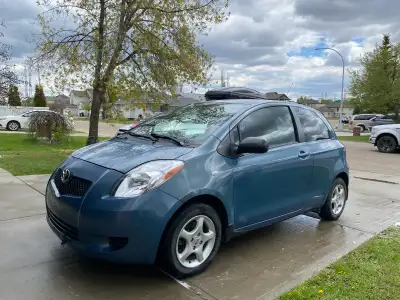 This reliable blue Toyota Yaris hatchback features a fuel-efficient engine and a compact design, per...