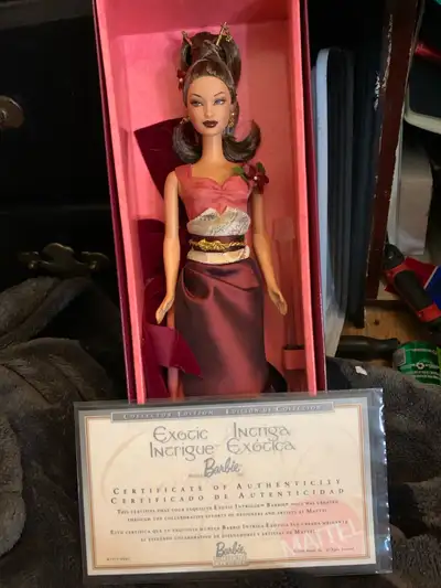This pre-owned Mattel Exotic Intrigue Barbie Collector Edition doll, designed exclusively for Avon,...