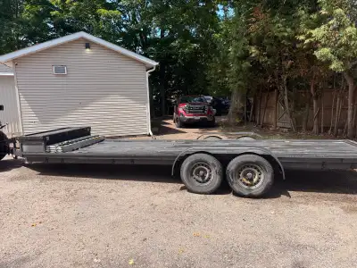 This tandem axle flat deck trailer is in good, previously owned condition, perfect for transporting...