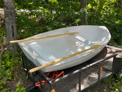 This is a sturdy row boat ready for the water, boasting a fresh coat of white paint and comes comple...