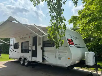 24' Jayfeather by Jayco. Comfortably sleeps four, but can sleep 6 if needed. Queen bed at rear of tr...