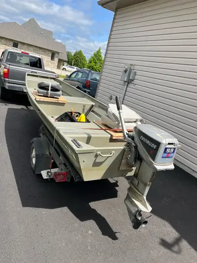 tracker toper 14’ with “9.9hp” evinrude 2 stroke and trailer. Motor runs great. Includes gas tank, t...