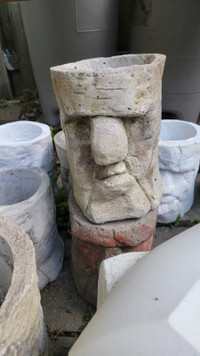 Concrete statues, garden planters and Moai heads