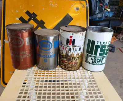 Selling a collection of four vintage oil cans, including Esso Automatic Transmission Fluid, Esso Sol...