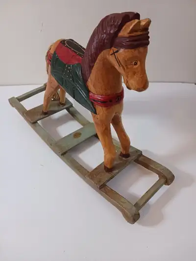 With a touch of rustic charm, this primitive carved wood tabletop rocking horse from Indonesia, Stan...