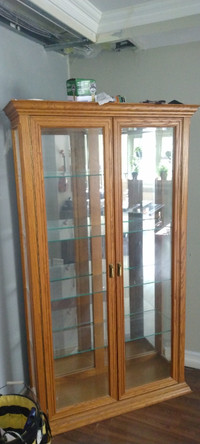 Solid oak display cabinet with four glass shelves,light inside.