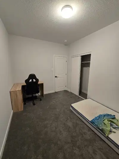 This room, furnished with a office desk, office chair, and bed (Frame is in the basement) is ideally...