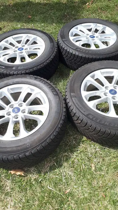 Set of alloy rims and tires in exellent condition from a 2022 ford escape tires are michelins xice w...