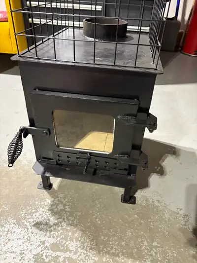 Wood stove. New not used. 14” wide by 21” high by 18” deep. 6” outlet. $750 obo 7807421074