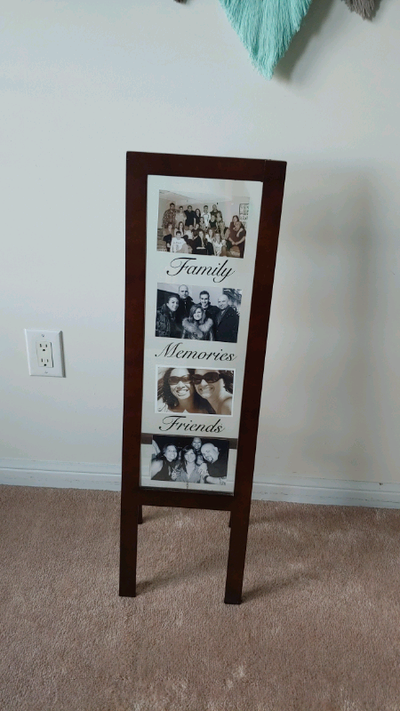 Self standing picture frame Dark brown wooden frame Has the words family friends and memories writte...