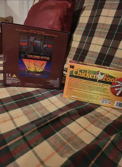 unopen boxes of Chicken foot(dominos/decimals) and a 300 piece puzzle from the online game Exploding...