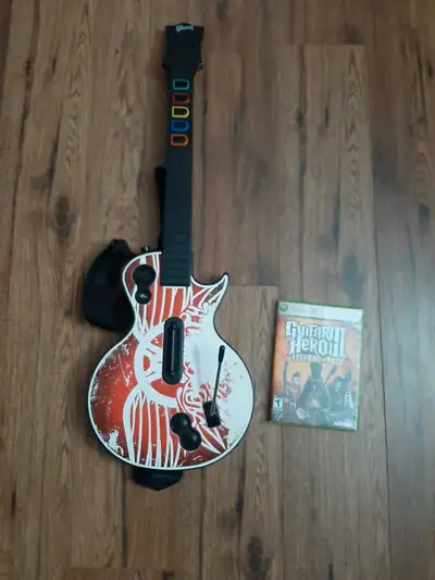Guitar hero controller. Works great! Comes with strap. Also comes with guitar hero 3 legends of rock...
