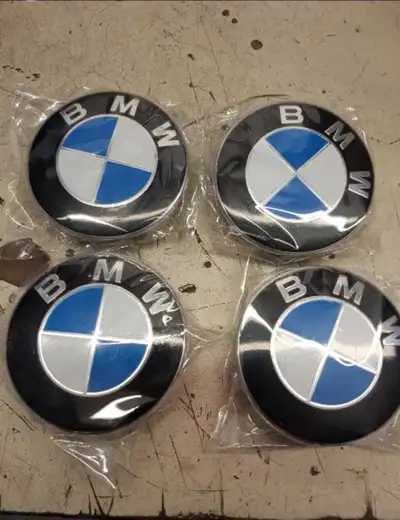 Brand BMW center caps new in the package. Set of four Oem fit 68mm center caps for BMW factory alloy...