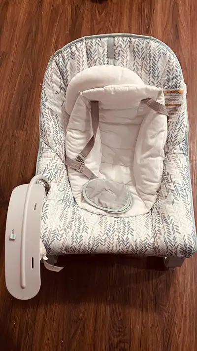 This appears to be an Ingenuity Keep Cozy 3-in-1 Grow with Me Vibrating Baby Bouncer featuring a neu...