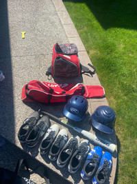Baseball equipment- 4 pairs of cleats, Rawlings bat, helmets